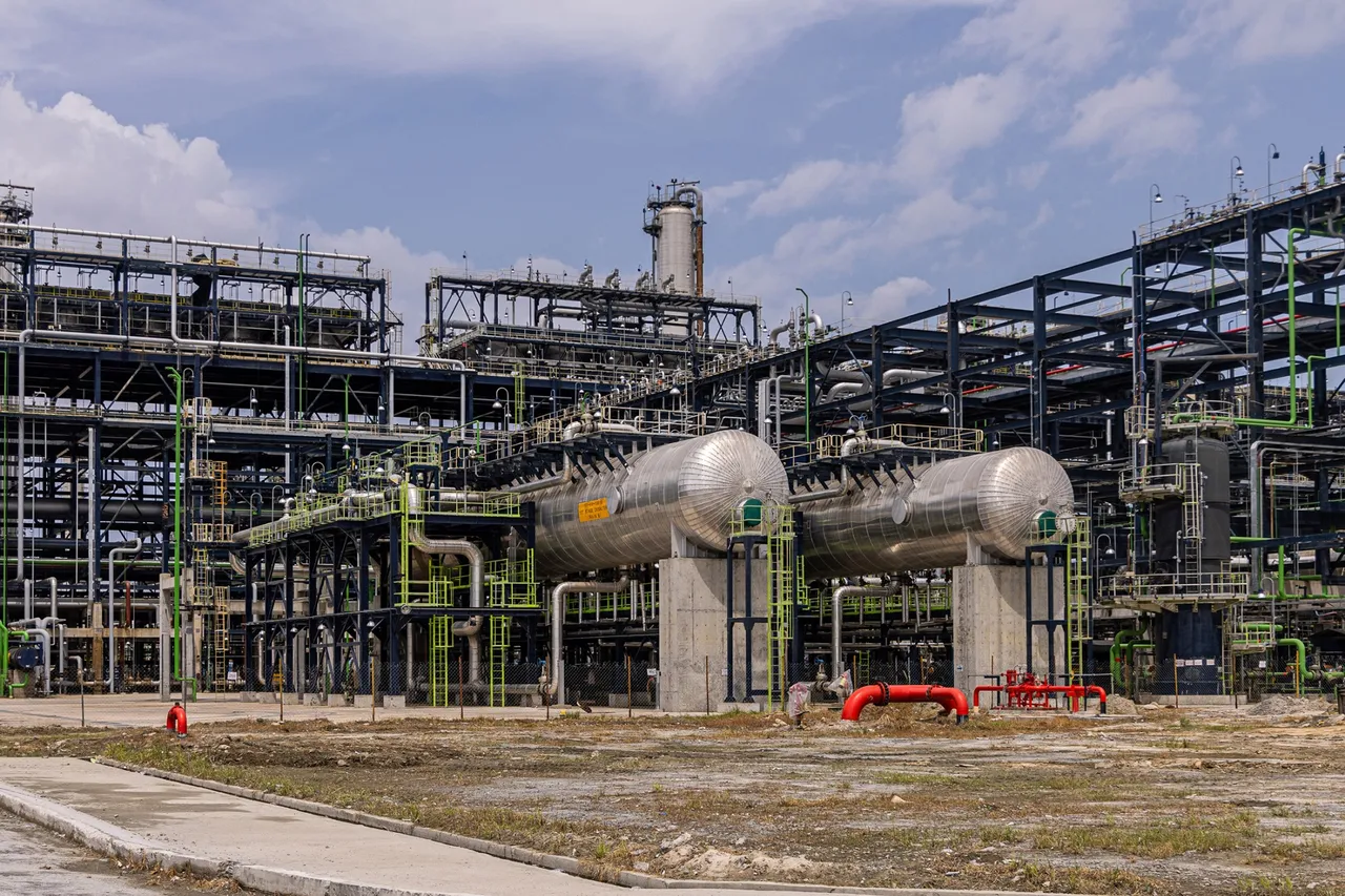 Large industrial structures and storage tanks at Aliko Dangote's oil refinery complex outside Lagos, Nigeria.