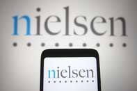 In this photo illustration, Nielsen Holdings logo is seen on