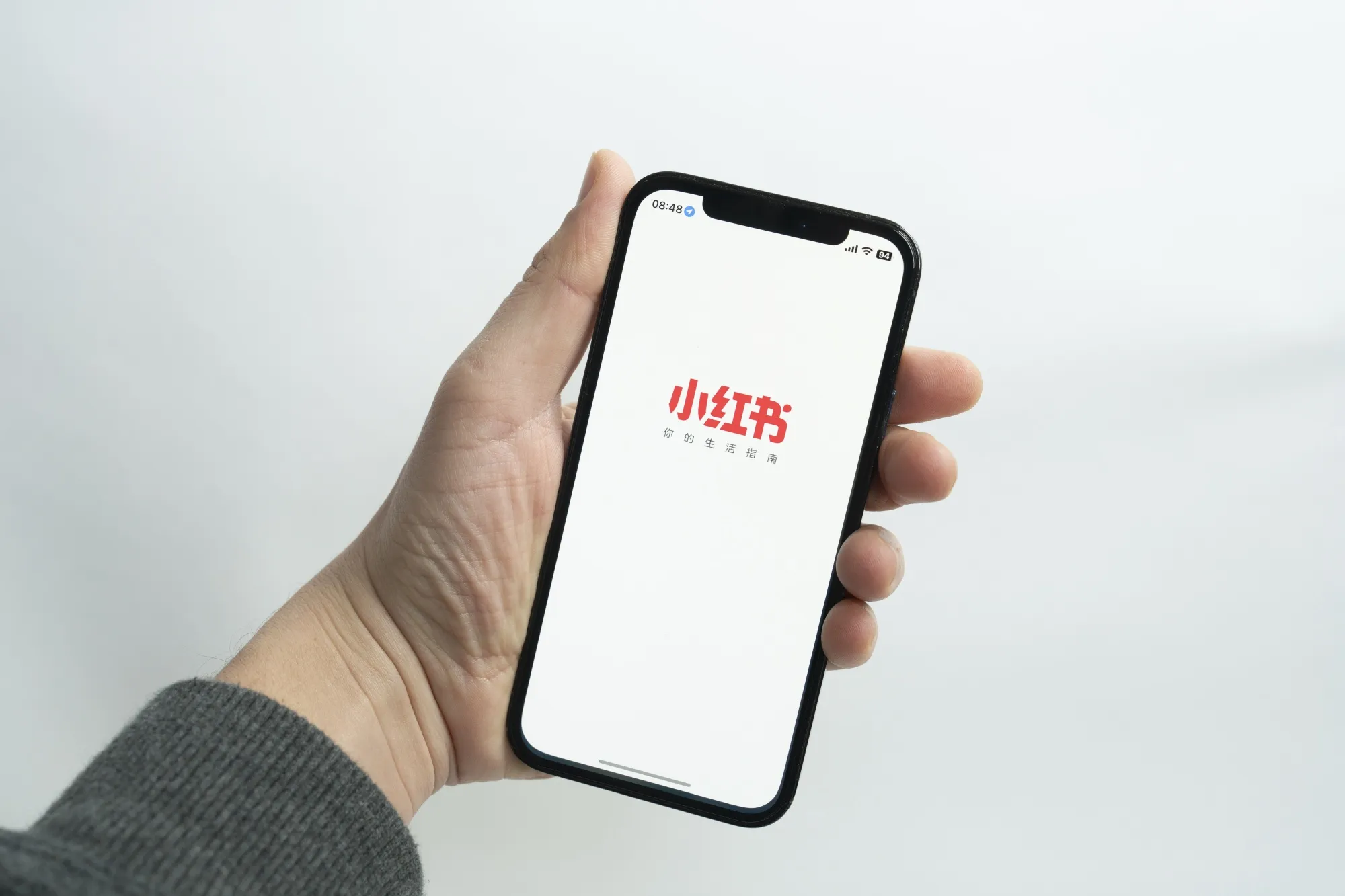 The Xiaohongshu logo on an iPhone.