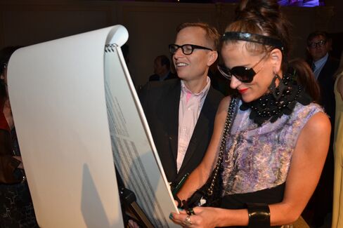 Artist Will Cotton and curator Stacy Engman make art during cocktail hour. Photographer: Amanda Gordon/Bloomberg