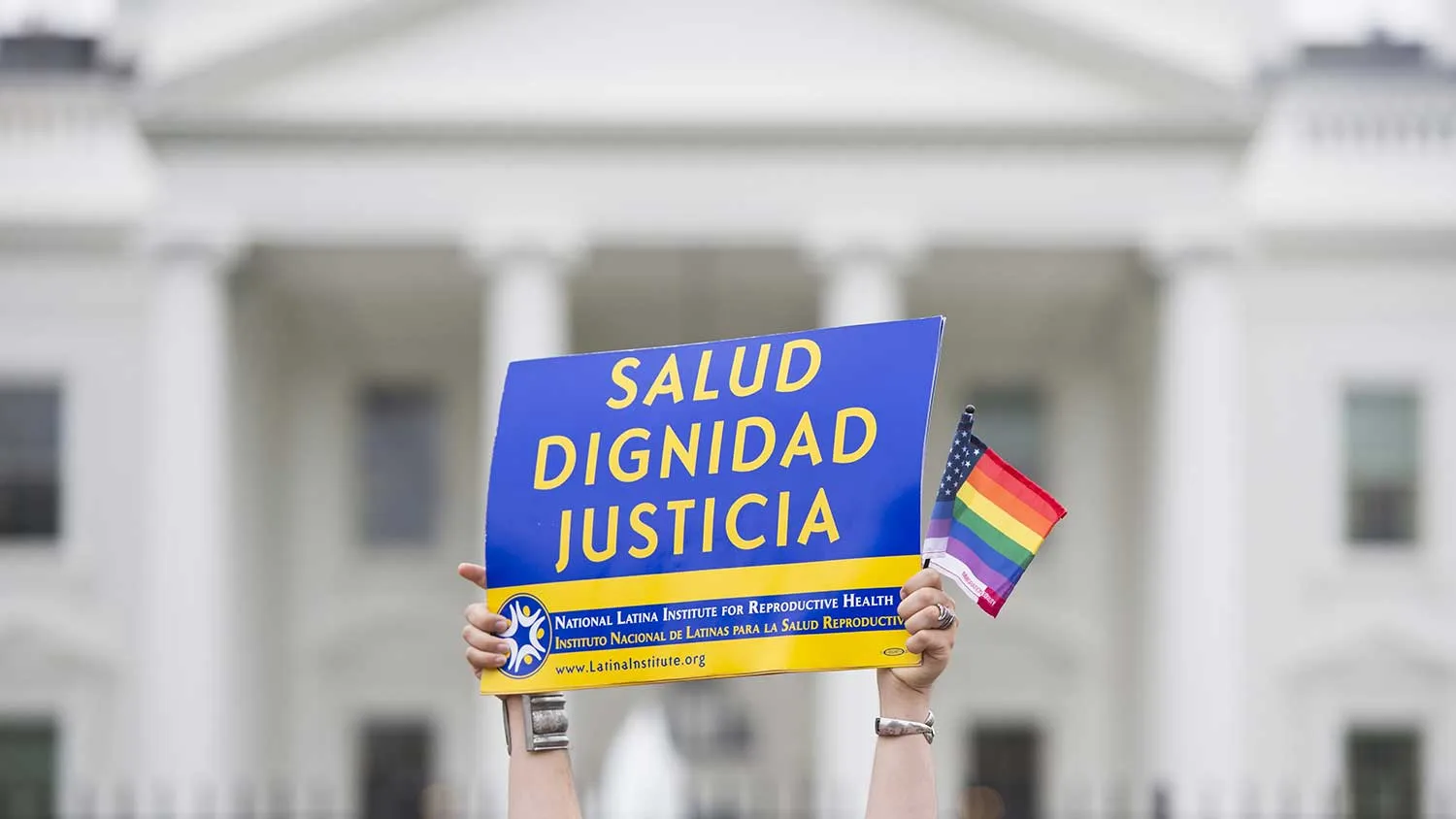Demonstrators wave flags and banners in front of the White House in Washington on October 11, 2009 as tens of thousands of gay activists marched to demand civil rights, a day after President Barack Obama vowed to repeal a ban on gays serving openly in the US military.
