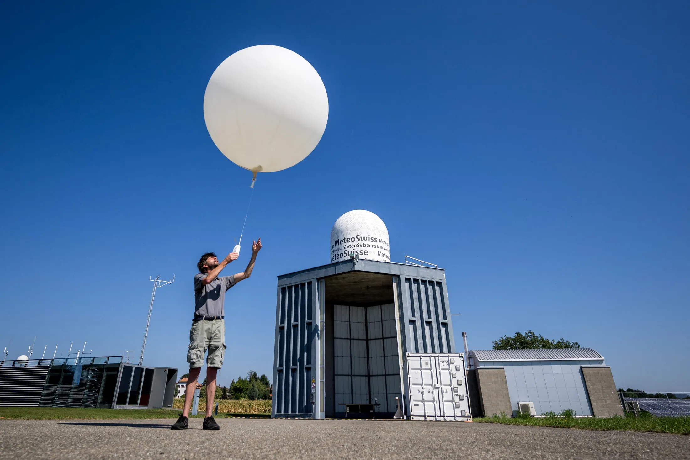 A meteorologist launches a weather balloon at MeteoSwiss station in Payerne, Switzerland.