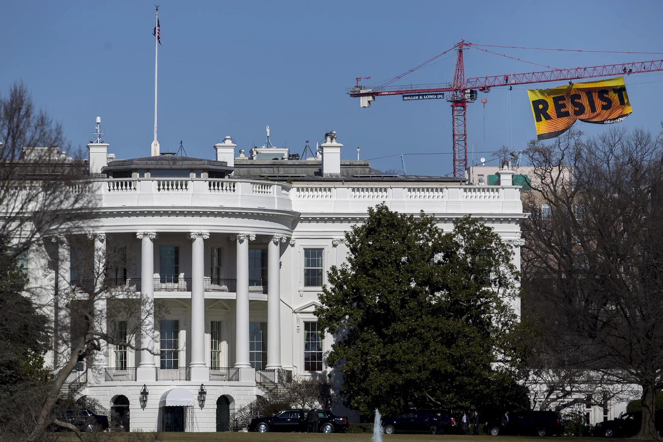 Greenpeace activists hang a banner off of a construction crane that reads 'Resist' past the White House in Washington, D.C., U.S., on Jan. 25, 2017. The protest came one day after the Trump administration issued a memorandum supporting completion of the Energy Transfer Partners LPs Dakota Access Pipeline.

