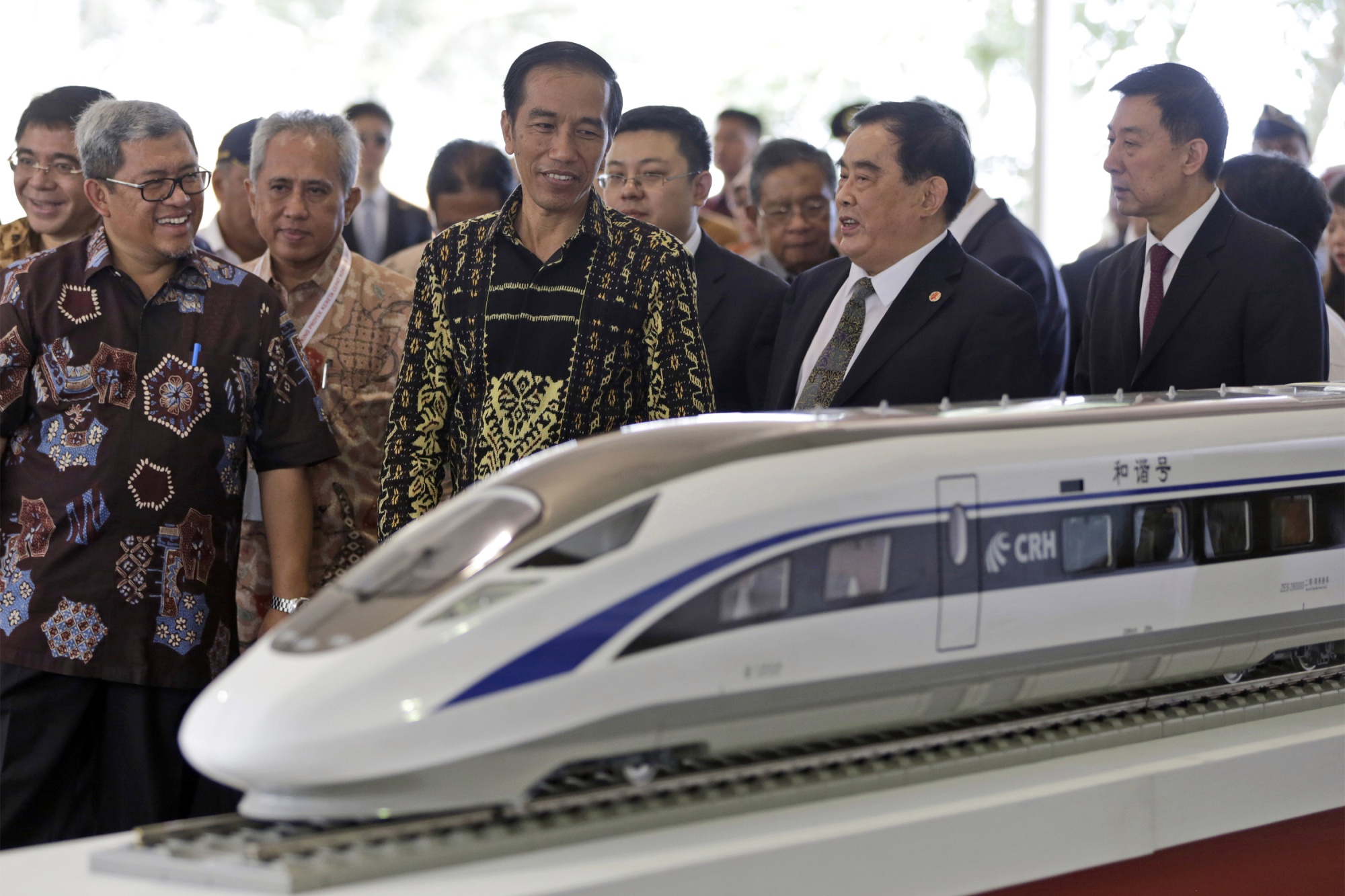 Indonesian President Joko Widodo, center, inspects a model train in 2016.