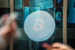 Signage for Bitcoin cryptocurrency in Hong Kong, China, on Wednesday, Nov. 26, 2025. The intense selling pressure that has weighed on Bitcoin in recent weeks looks to be easing, raising hopes that the token's brutal slide is nearing an end.