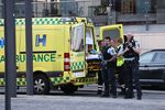 An ambulance and armed police during the evacuation of the Fields shopping center in Copenhagen, on July 3.