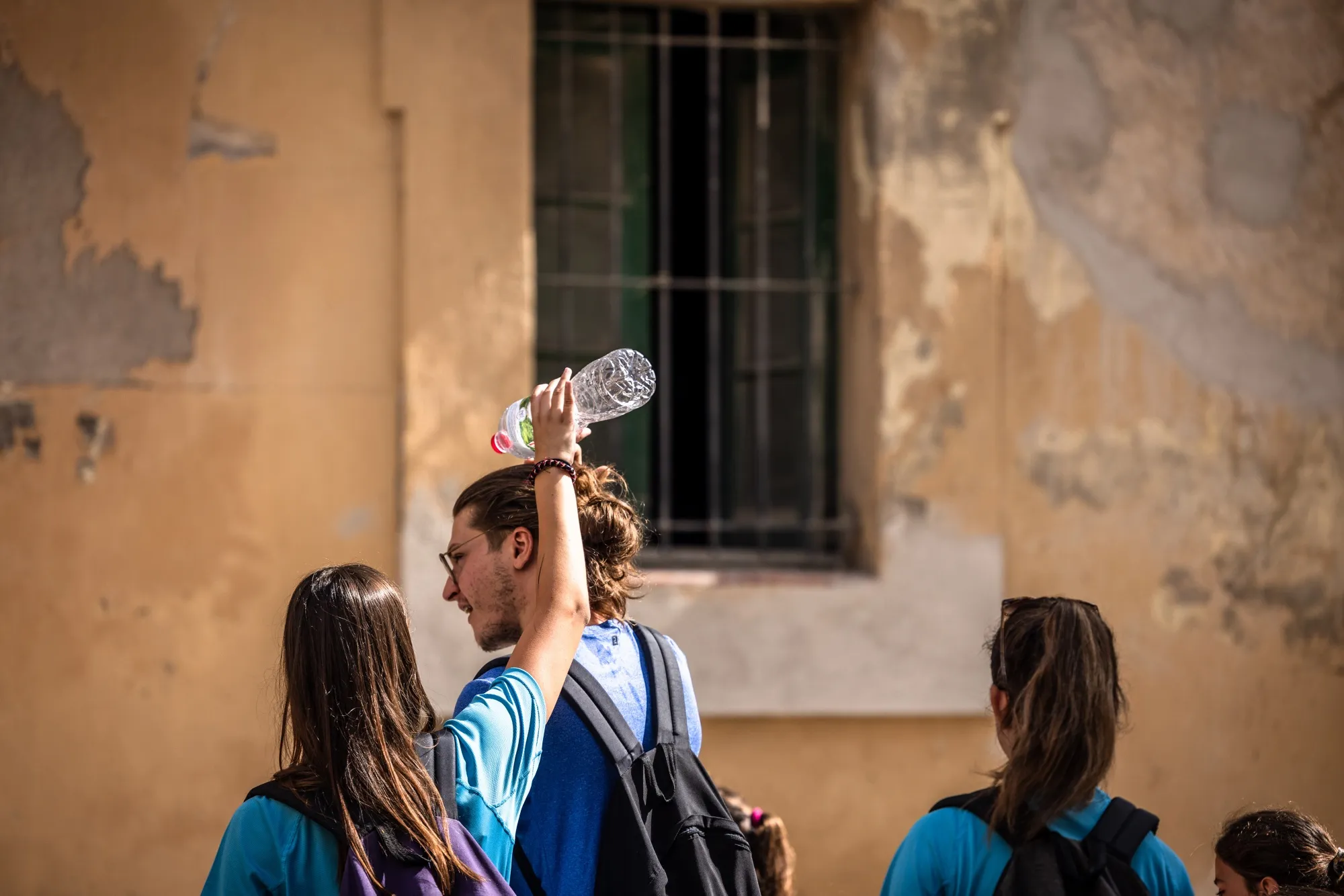 A person pours&nbsp;water over the head of a friend to cool down in La Bisbal d'Empord, Girona, Spain, July 19, 2023.&nbsp;