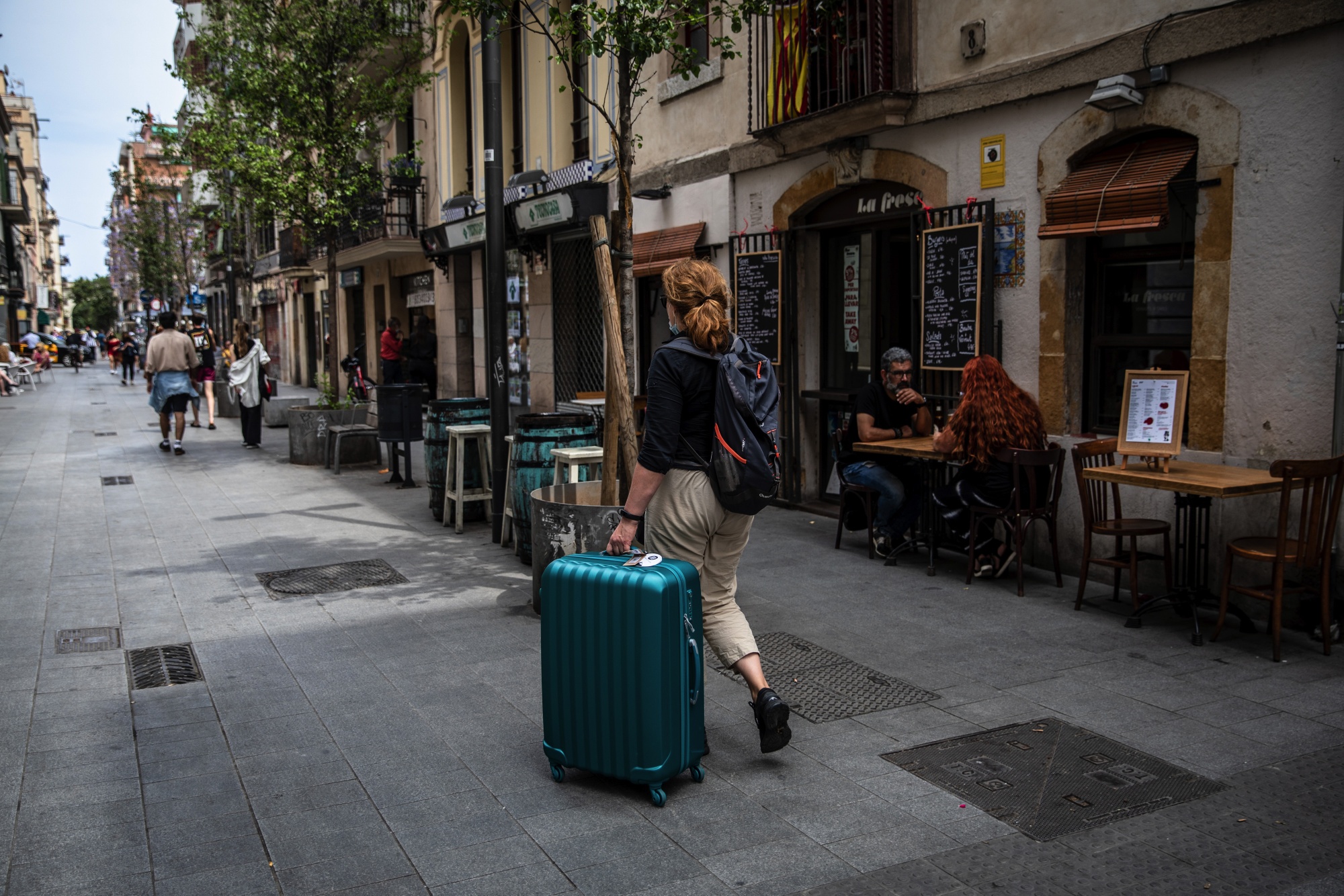 A tourist wheels luggage in the Barceloneta district in Barcelona, Spain, on Saturday, June 5, 2021.