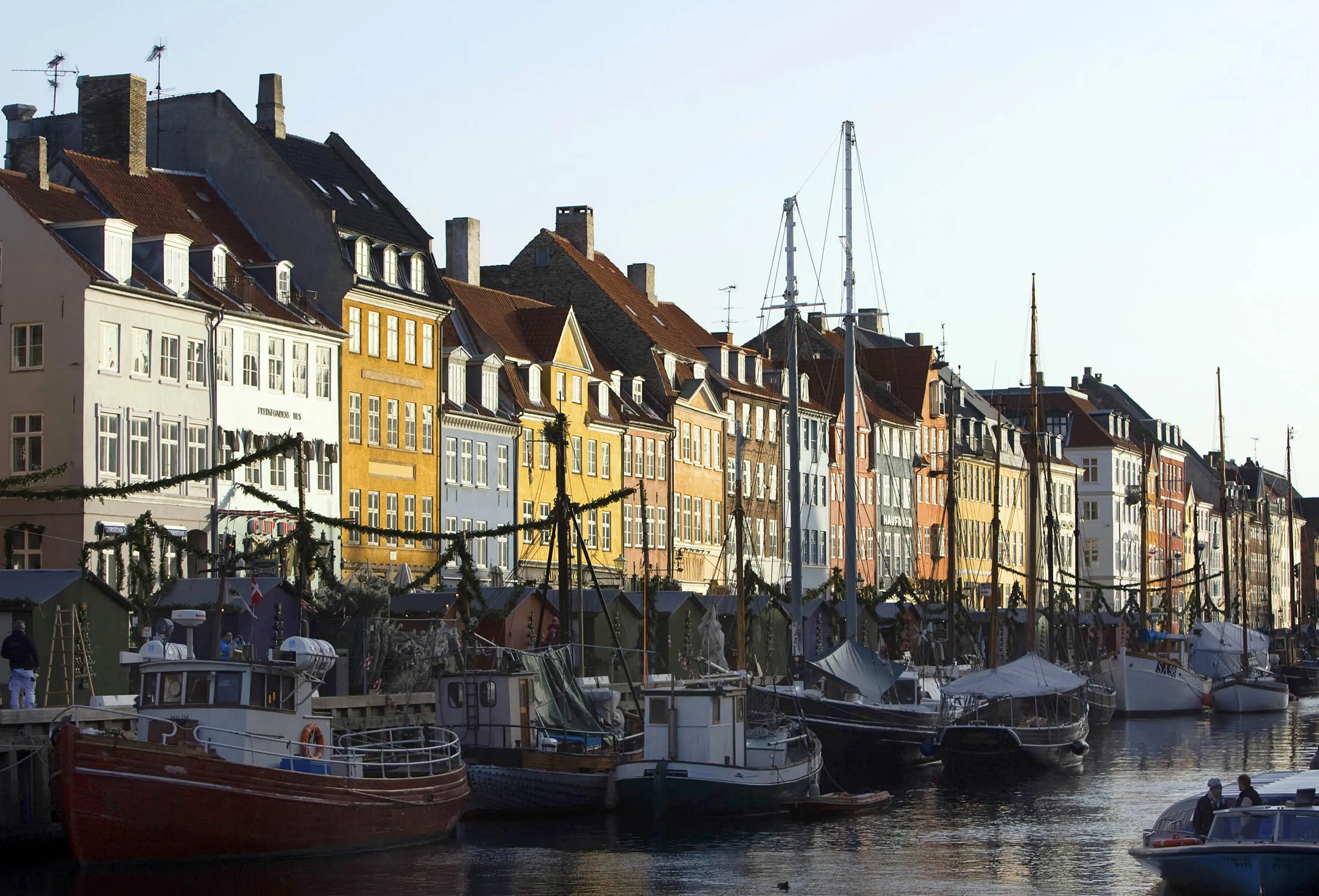 Boats sit moored in the canal at Nyhavn in Copenhagen.
