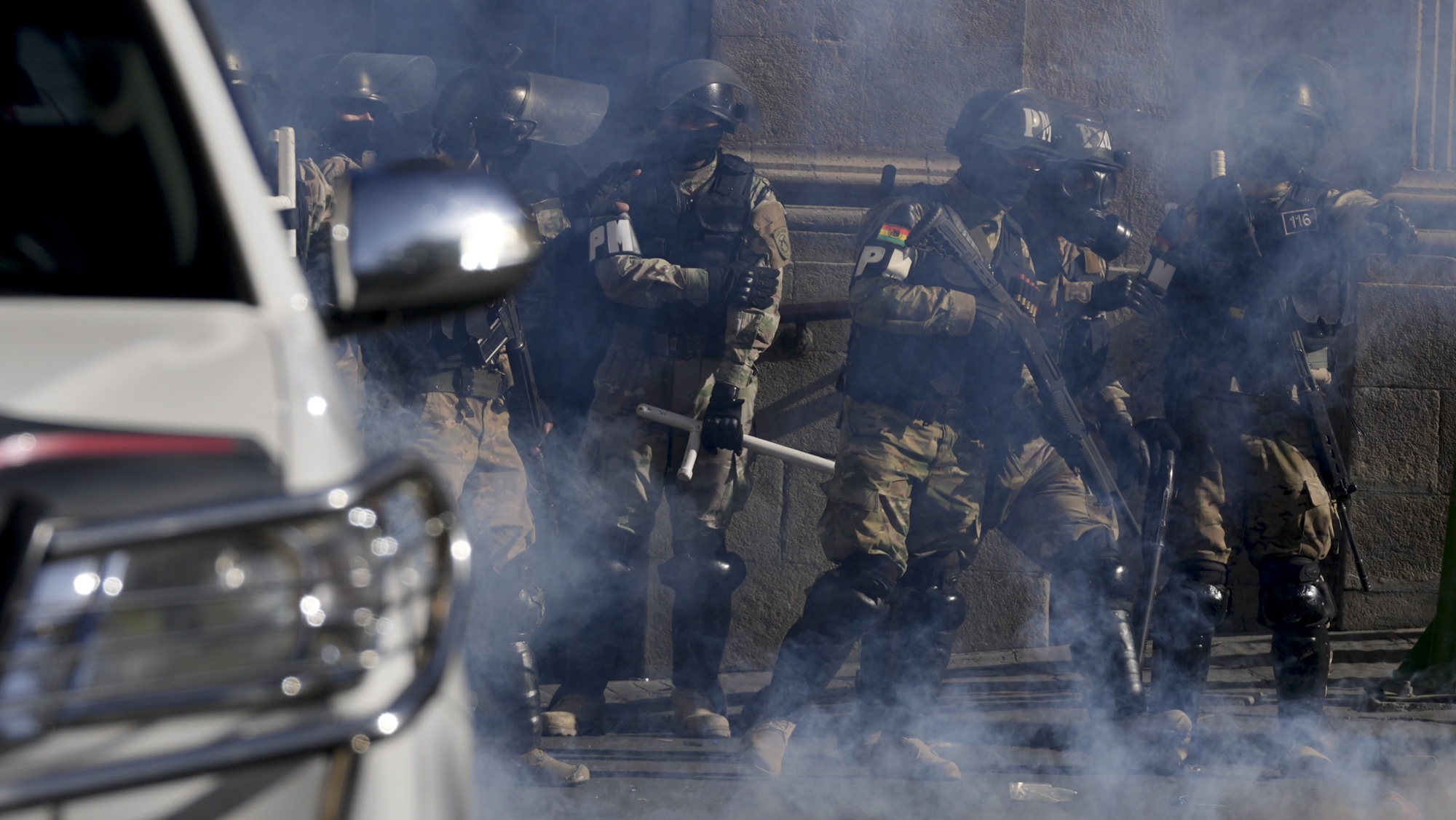 Military Police stand guard amid tear gas they fired outside the presidential palace in Plaza Murillo in La Paz, Bolivia, on June 26.&nbsp;