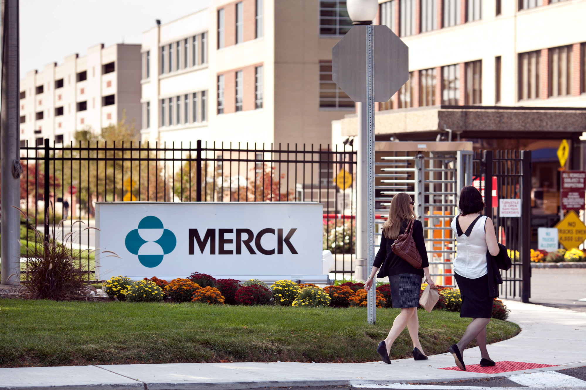 Workers enter a Merck facility located in Summit, New Jersey, Tuesday, October 1, 2013.
