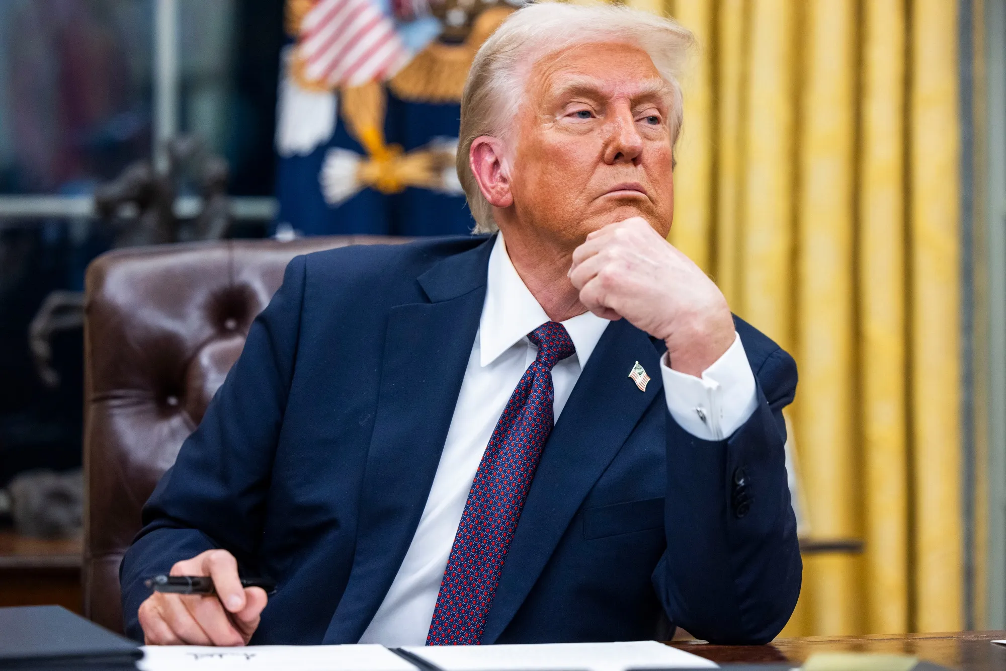 US President Donald Trump with an executive order during a signing ceremony in the Oval Office of the White House.