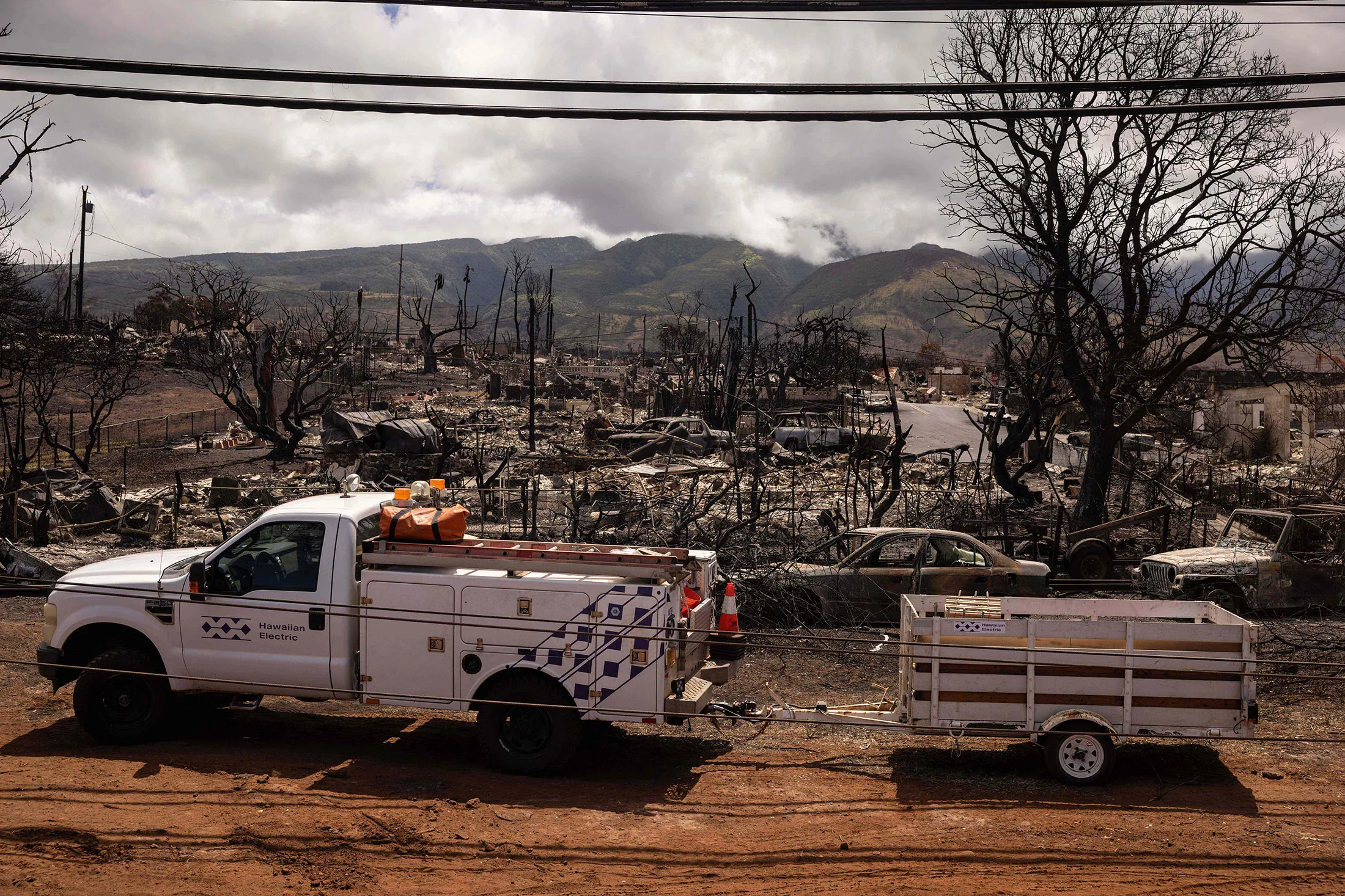 A Hawaiian Electric truck near a destroyed neighborhood following the Maui wildfires in Lahaina, Hawaii on Aug. 16, 2023.