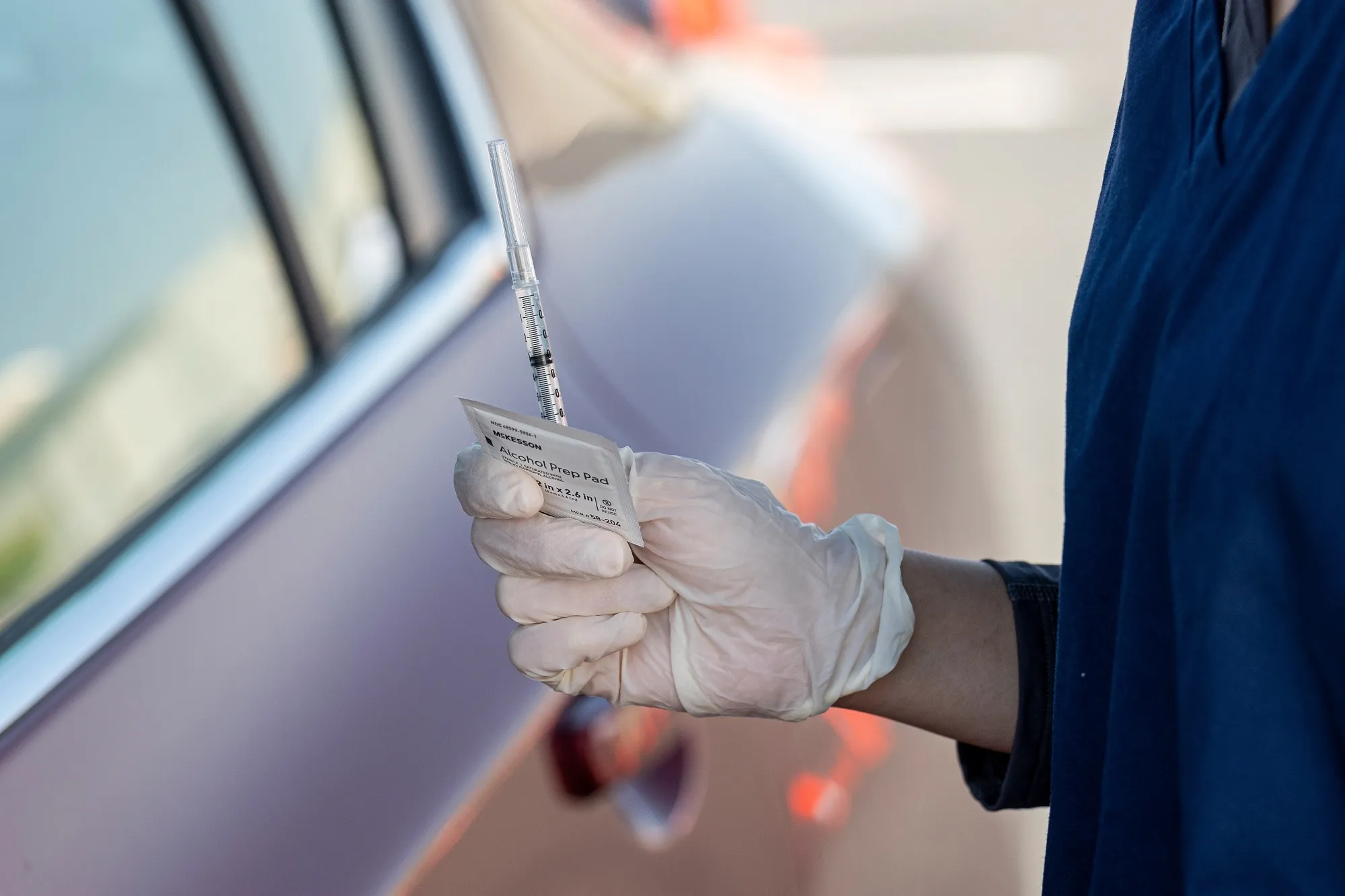 A healthcare worker holds a syringe with a dose of the Pfizer-BioNTech Covid-19 vaccine at a clinic in McClellan, California.