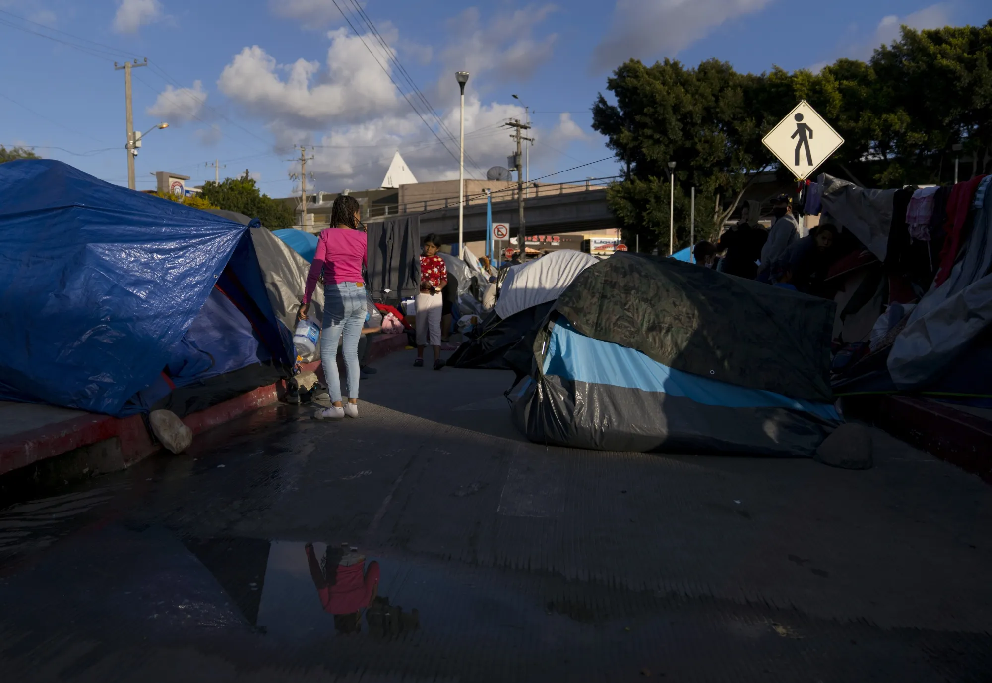 Migrants seeking asylum hearings wait at a makeshift housing camp in Tijuana, Mexico, on&nbsp;March. 21.&nbsp;
