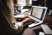 RF Midsection of female lawyer using laptop while typing at desk in office