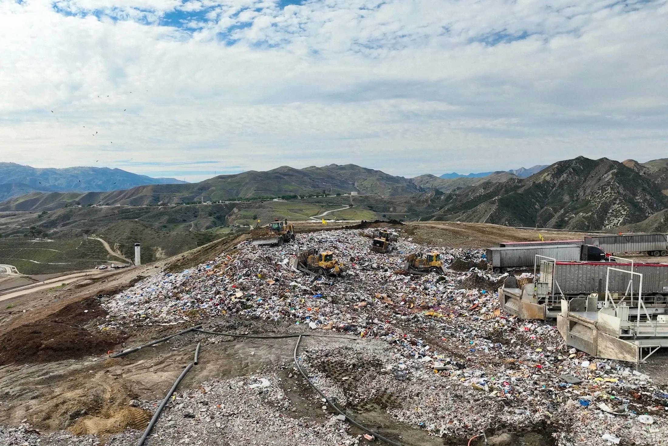 Bulldozers compact and cover trash at Chiquita Canyon Landfill in Los Angeles County.