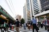 Pedestrians wearing protective masks cross a street in the Yurakucho district of Tokyo, Japan.