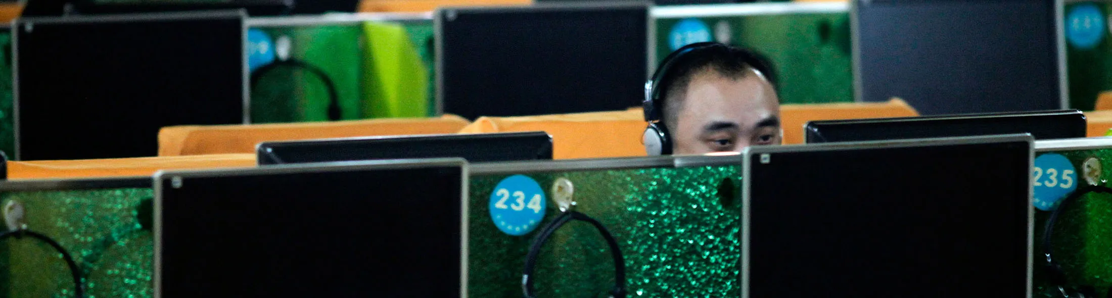 Customers use computers at an internet cafe in Shanghai.
