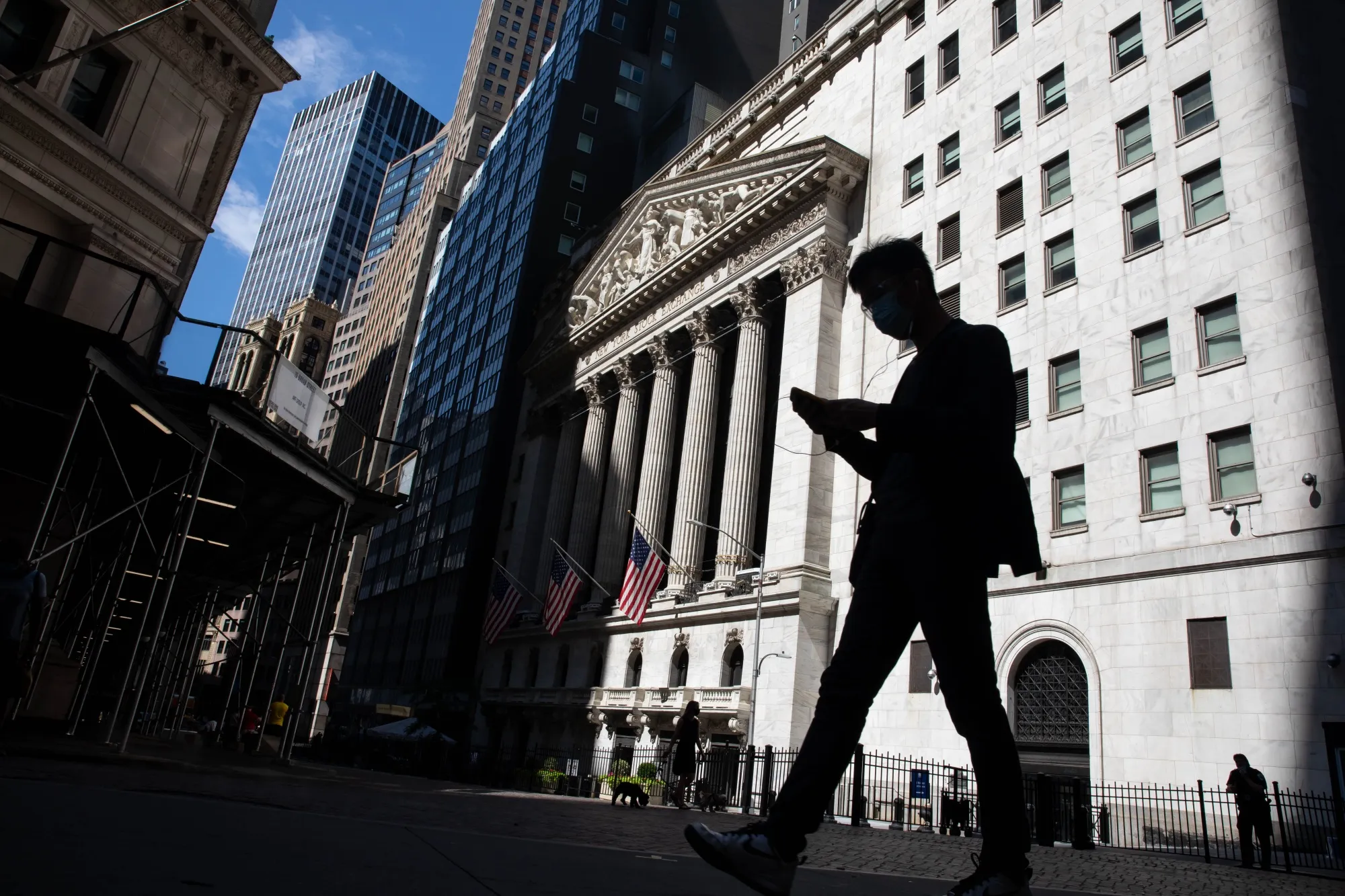 A pedestrian pass in front of the New York Stock Exchange.