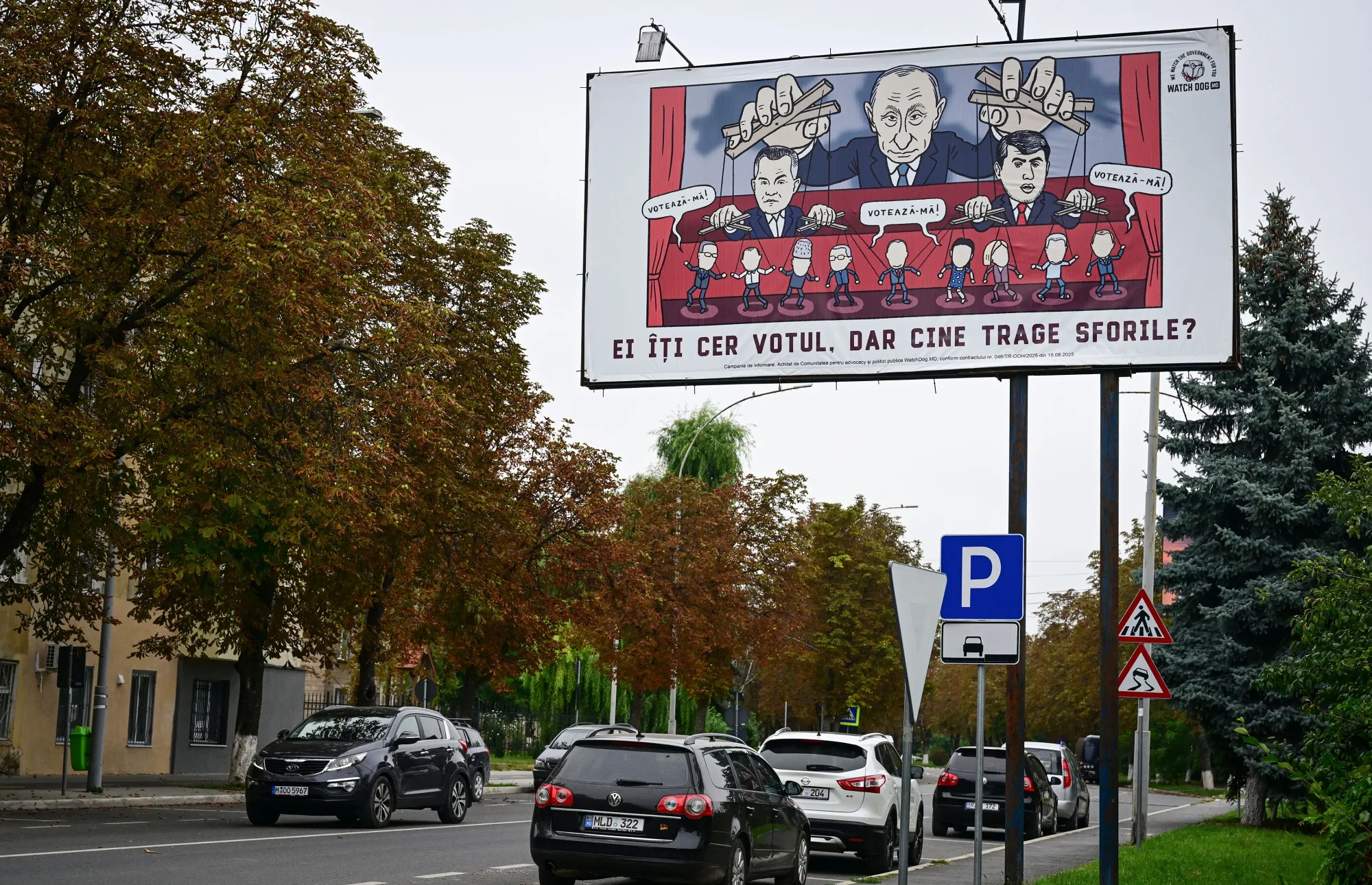 A billboard in Ungheni, Moldova, portrays a caricature of Vladimir Putin pulling the strings in the country’s upcoming election.