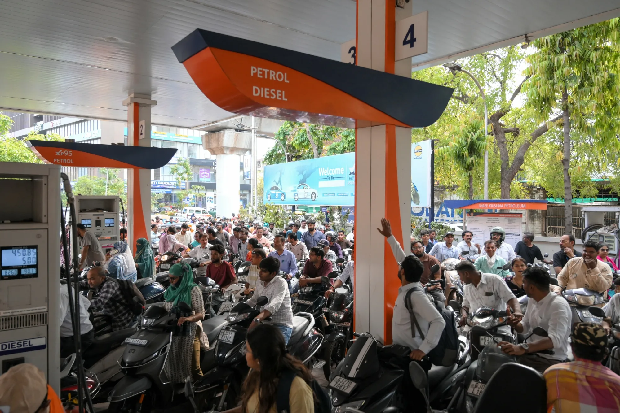 People queue to refuel at a fuel station in Ahmedabad, India.
