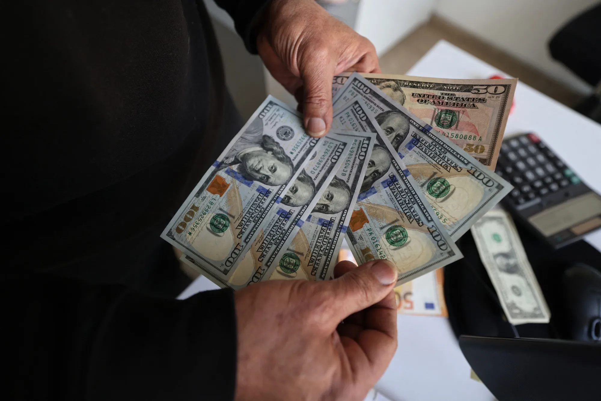 An Iranian man shows US dollar banknotes in Tehran.