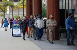 People wait in line to cast their ballots outside Frank P. Zeidler Municipal Building on the first day of in-person early voting for the November 3, 2020 elections in Milwaukee, Wisconsin, on October 20, 2020.