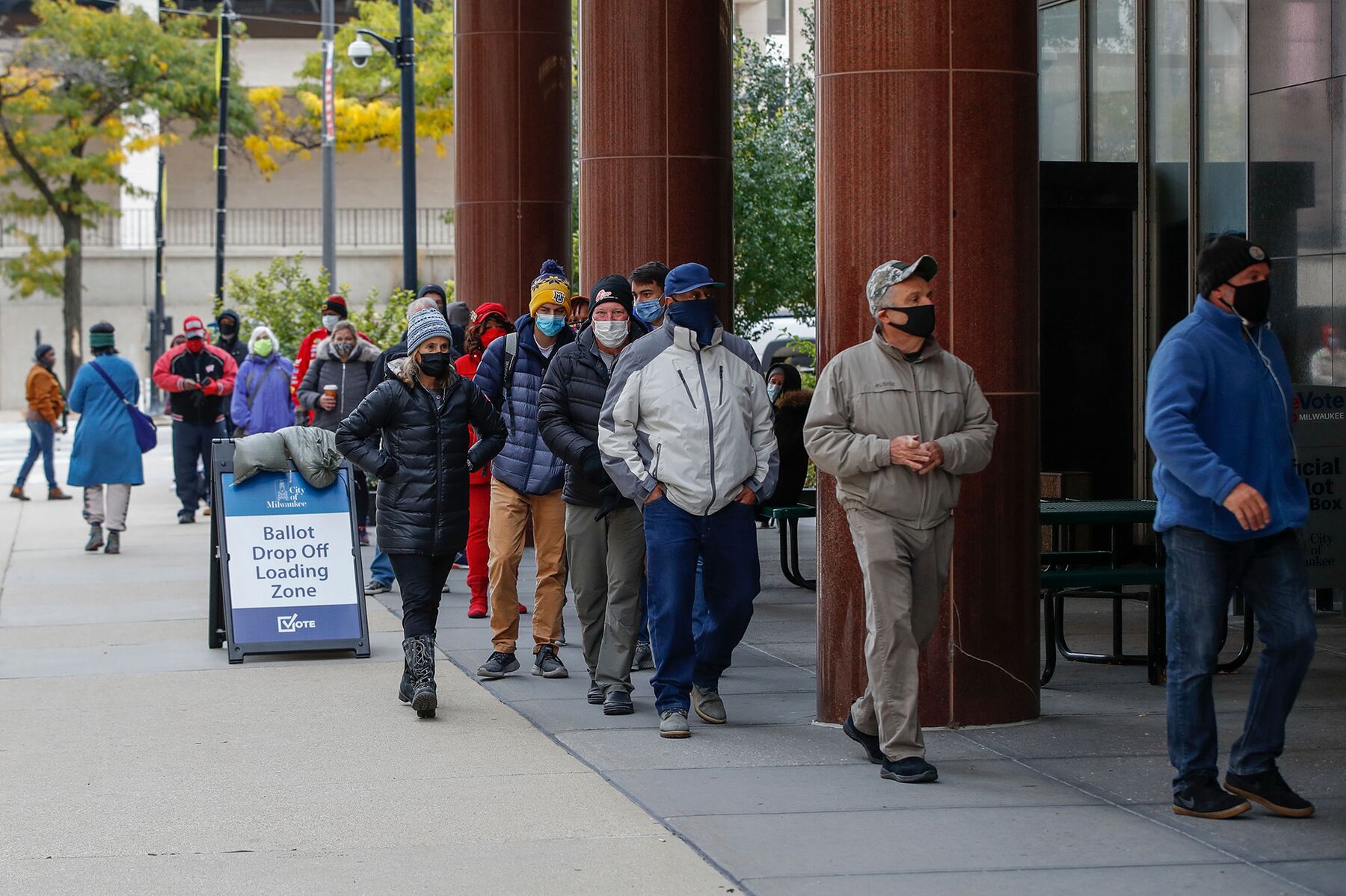 People wait in line to cast their ballots outside Frank P. Zeidler Municipal Building on the first day of in-person early voting for the November 3, 2020 elections in Milwaukee, Wisconsin, on October 20, 2020.