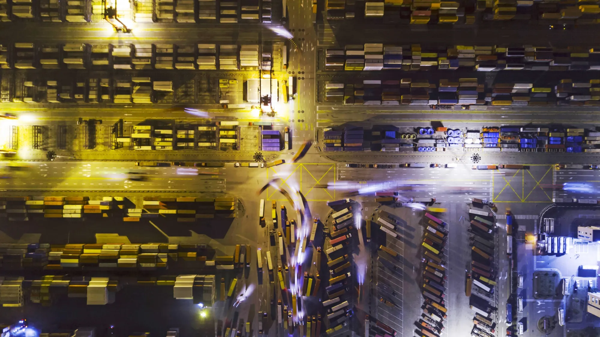Light trails left by trucks run past containers at the Yangshan Deepwater Port, Shanghai.