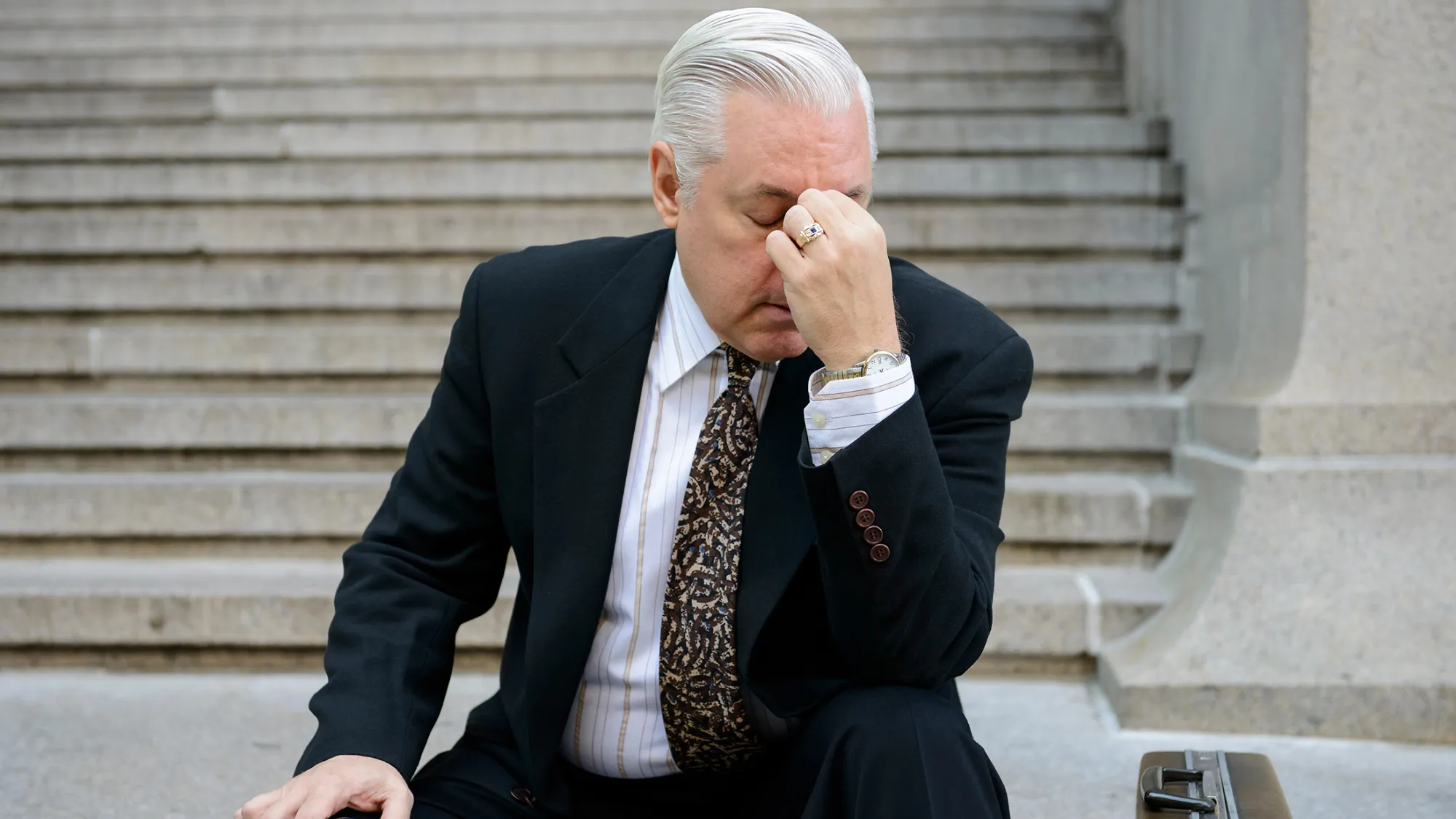 Stressed businessman on steps
