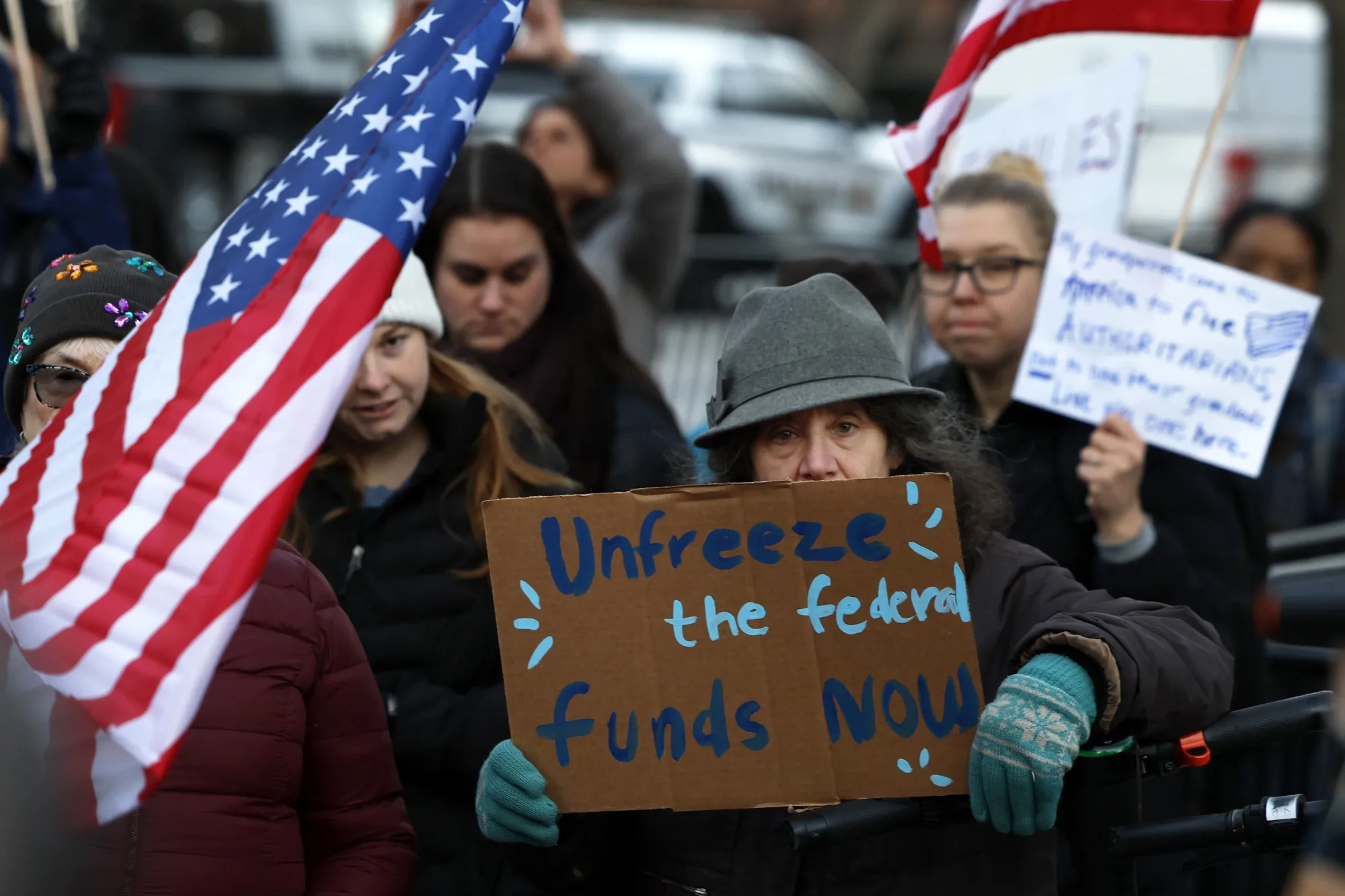 Protestors rally near the White House in Washington on Jan. 28 in opposition to President Donald Trump’s attempt to freeze trillions of dollars in federal funding.