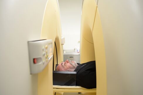 David Hay lies on a bed inside a PET, or positron emission tomography, scanner at the Austin Hospital in Melbourne. Photographer: Carla Gottgens/Bloomberg
