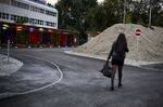 A prostitute walks past so-called ‘sex boxes’ in Zurich.