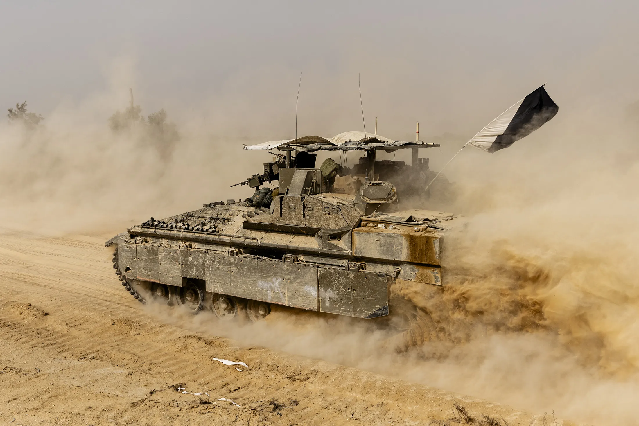 An Israeli armored personnel carrier moves near the border with the Southern Gaza Strip on May 25, 2024.