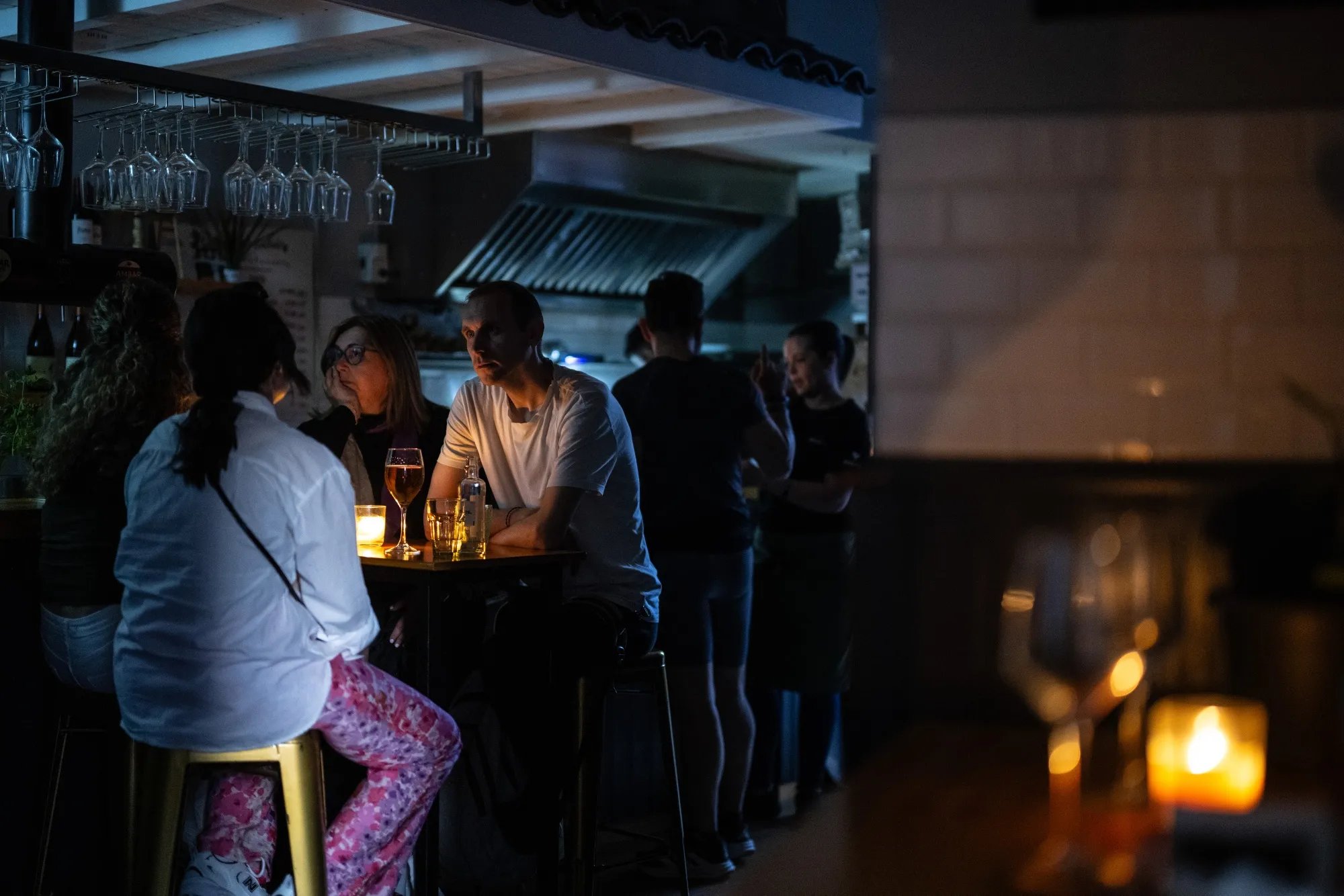 Customers in a candle lit restaurant during a power outage in Ourense, Spain, on April 28.