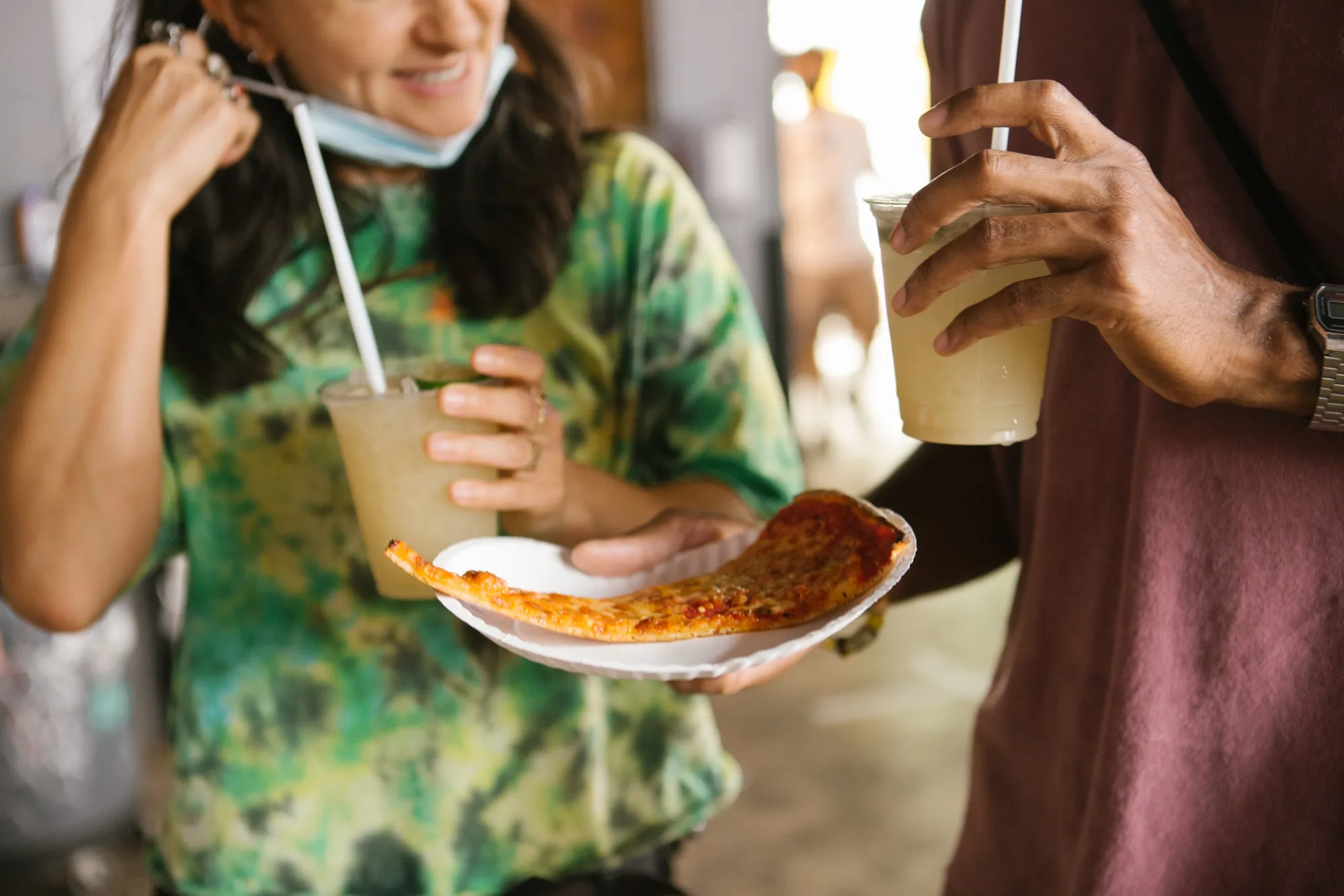 Customers hold&nbsp;free pizza and cocktails after receiving a dose Pfizer-BioNTech Covid-19 vaccination at a bar in Miami, Florida,&nbsp;on&nbsp;May 8.&nbsp;