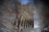 The New York Stock Exchange (NYSE) is reflected in a puddle in New York, U.S.