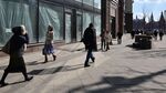 People walk past an empty retail space on Tverskaya street in central Moscow on March 16.&nbsp;