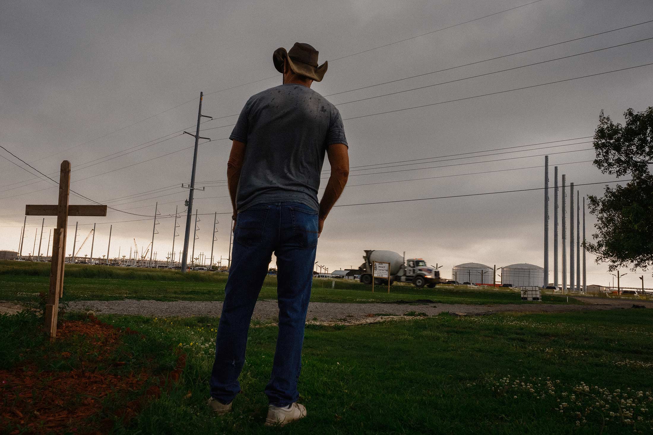 Mike Steel, photographed here facing away from the camera, lives in front of the Meta construction site and leases land to food truck owners. “We have to embrace it, because it’s here,” he says. “You can complain as much as you want, but it’s not gonna change anything.”