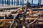 State employees remove debris from a beach in Aptos, California, on Jan. 17.