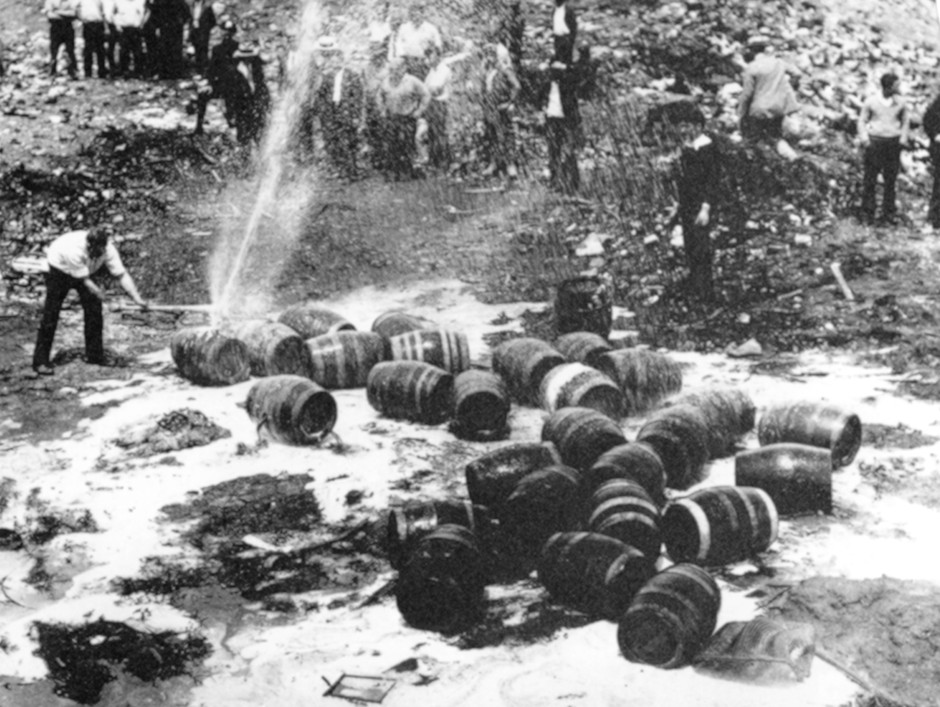 Beer barrels are destroyed by prohibition agents at a dump in New York City, June 18, 1931.