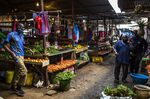 Customers browse fresh produce on sale at Toi market in Nairobi, Kenya.
