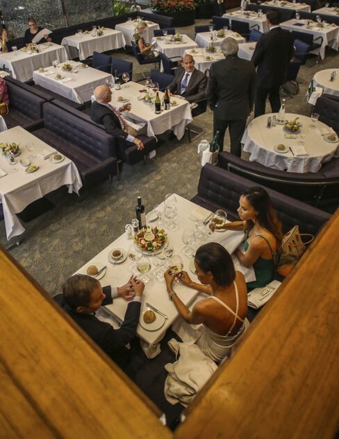 Patrons enjoy lunch service at the Four Seasons restaurant in New York, U.S., on Wednesday, July 13, 2016.