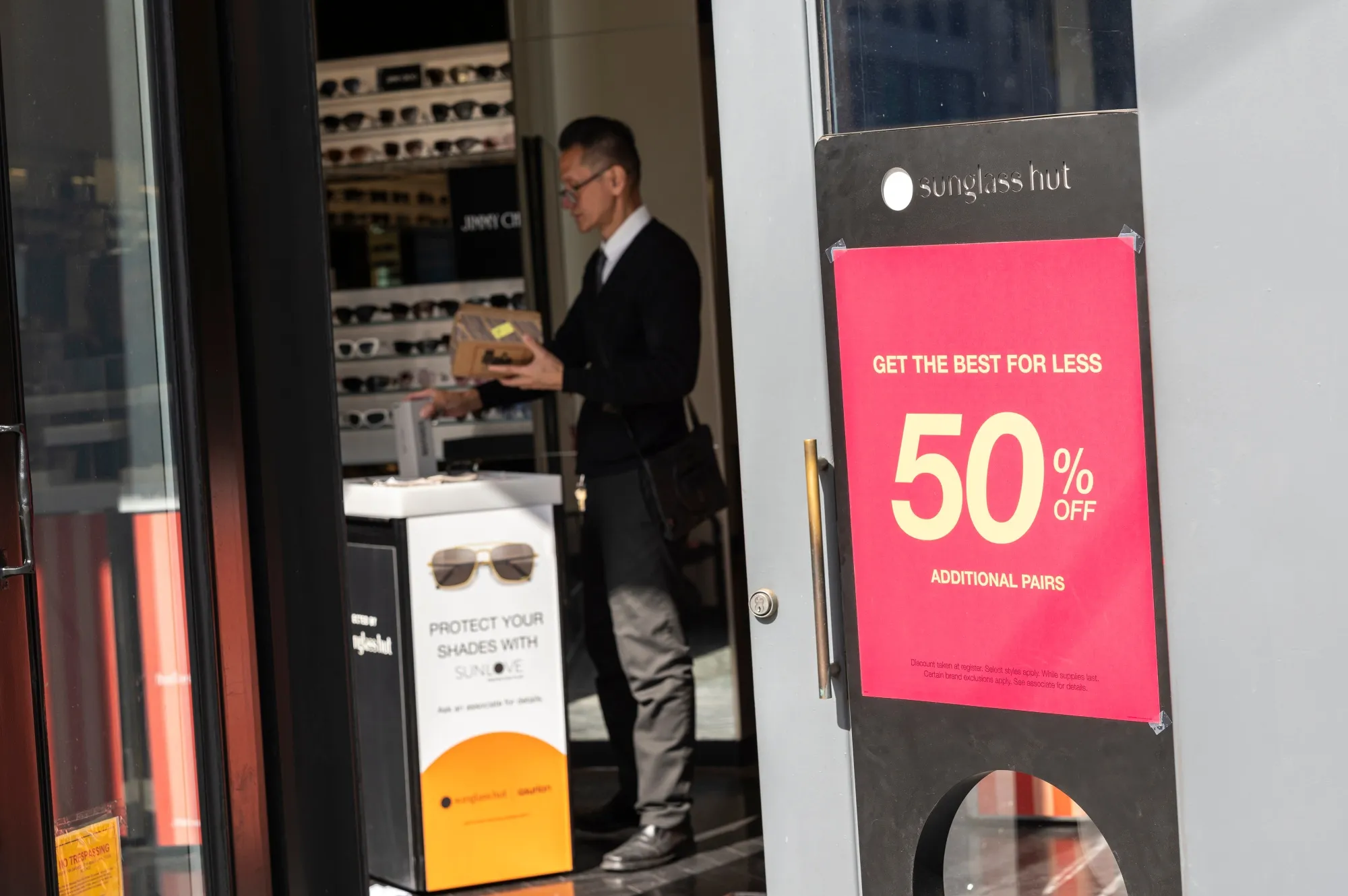 A worker inside a Sunglass Hut store in San Francisco.&nbsp;Data released this week showed signs inflation is easing.