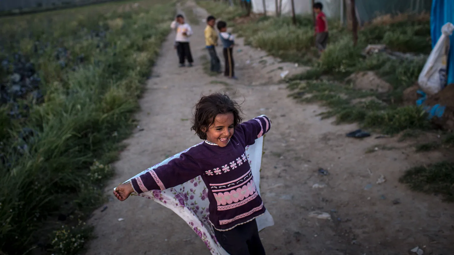 A Syrian refugee girl plays outside her home at a tent camp on April 27, 2016, in Izmir, Turkey.

