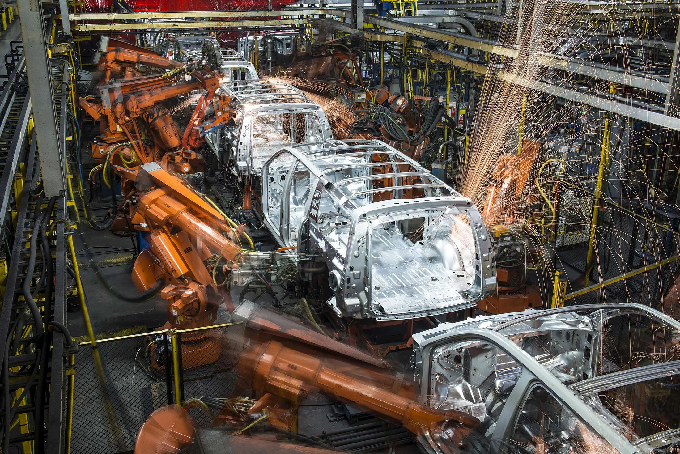 Robotic machines weld together the frames of sports utility vehicles (SUV) during production at the General Motors Co. (GM) assembly plant in Arlington, Texas, U.S., on Thursday, March 10, 2016. The U.S. Census Bureau is scheduled to release business inventories figures on March 15.
