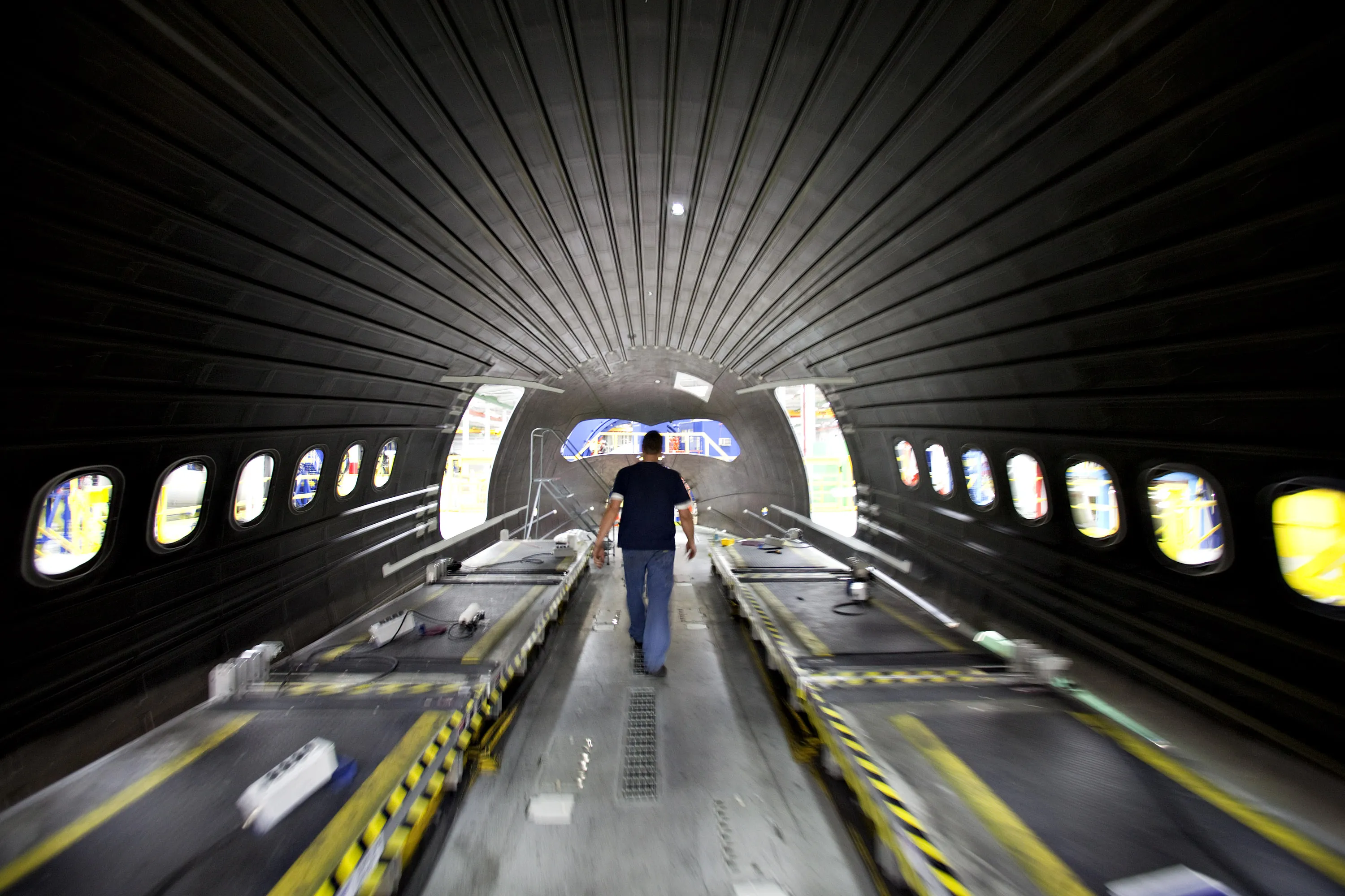 A worker walks inside a Boeing composite fuselage section at Spirit AeroSystems in Wichita, Kansas in 2010.