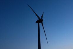 A Wind Turbine Against A Blue Sky