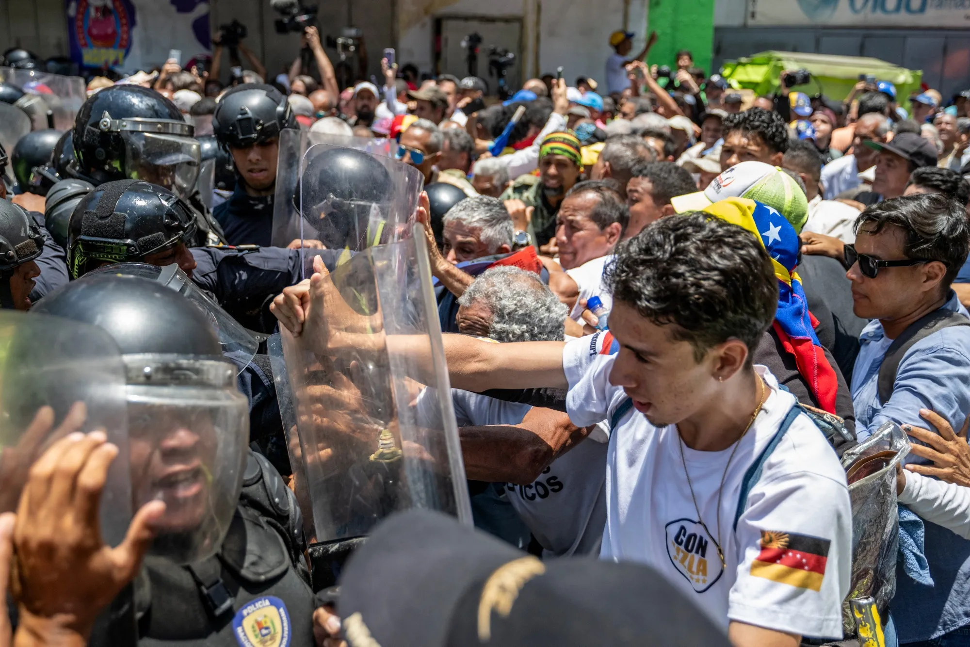 Demonstrators confront law enforcement officers during a protest in Caracas on April 9.
